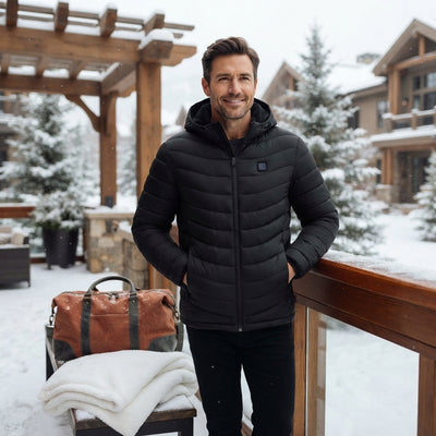 A man wearing a heated winter parka standing in a snowy environment, looking warm and comfortable.